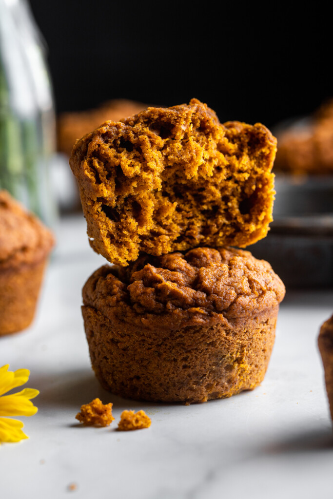 two Vegan Pumpkin Muffins stacked on top of eachother
